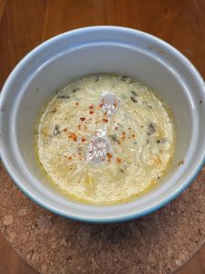 Finished dish, depicting two eggs in anchovy cream sauce.